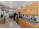 Well-lit kitchen featuring wooden cabinets, granite countertops, and modern black appliances at 10566 E Bogart Ave, Mesa, AZ 85208