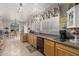 Bright kitchen with tile flooring, wooden cabinets, granite countertops, and a stainless steel dishwasher at 10566 E Bogart Ave, Mesa, AZ 85208