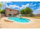 This spacious backyard includes a stunning pool with a basketball hoop and outdoor seating area at 10566 E Bogart Ave, Mesa, AZ 85208