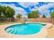 This pristine pool features built-in steps and a basketball hoop, perfect for Gathering fun and relaxation at 10566 E Bogart Ave, Mesa, AZ 85208