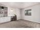 Empty bedroom featuring carpet, a built-in desk and shelves, and a window at 11000 N 91St Ave # 101, Peoria, AZ 85345