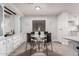 Bright dining room with a round glass table, stylish seating, and lovely built-in features at 11000 N 91St Ave # 101, Peoria, AZ 85345