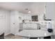Spacious kitchen featuring white cabinets, stainless steel appliances, and wood-look floors at 11000 N 91St Ave # 101, Peoria, AZ 85345