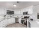 Bright, newly renovated kitchen with stainless steel appliances, white cabinets, and light countertops at 11000 N 91St Ave # 101, Peoria, AZ 85345