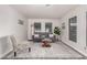 Inviting living room featuring neutral walls, grey sofa, and bright natural light at 11000 N 91St Ave # 101, Peoria, AZ 85345