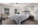 Cozy main bedroom with two windows, carpet, and floral print bedding at 11000 N 91St Ave # 101, Peoria, AZ 85345