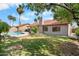 Home's backyard featuring a pool, grass area, and desert landscaping at 11106 E Clinton St, Scottsdale, AZ 85259
