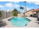 Backyard featuring a pool, lush landscaping, and privacy fence at 11106 E Clinton St, Scottsdale, AZ 85259