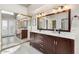 Elegant bathroom featuring a double vanity, tile flooring and large mirror at 11106 E Clinton St, Scottsdale, AZ 85259