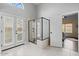 Bright bathroom featuring a tile shower and a door to the backyard at 11106 E Clinton St, Scottsdale, AZ 85259