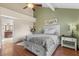 Comfortable bedroom with ceiling fan, wood floors and en suite bathroom at 11106 E Clinton St, Scottsdale, AZ 85259
