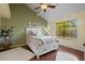Comfortable bedroom with ceiling fan, wood floors and large window at 11106 E Clinton St, Scottsdale, AZ 85259