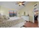 Comfortable bedroom with ceiling fan, wood floors and dresser with mirror at 11106 E Clinton St, Scottsdale, AZ 85259