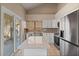 Bright kitchen with granite countertops, stainless appliances and a sliding glass door at 11106 E Clinton St, Scottsdale, AZ 85259
