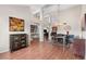 Open-concept living room featuring wood floors, high ceilings, and natural light throughout the space at 11106 E Clinton St, Scottsdale, AZ 85259
