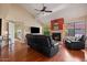 Comfortable living room featuring a cozy fireplace, leather furniture, and hardwood floors throughout at 11106 E Clinton St, Scottsdale, AZ 85259