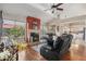 Bright living room featuring a fireplace, leather recliners, and hardwood floors providing a cozy atmosphere at 11106 E Clinton St, Scottsdale, AZ 85259