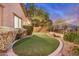 Beautifully landscaped backyard with artificial turf, creating a low-maintenance and inviting outdoor oasis at 12451 W Nadine Way, Peoria, AZ 85383