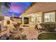 Charming backyard featuring a stone patio, fountain, fireplace, and lush landscaping for outdoor enjoyment at 12451 W Nadine Way, Peoria, AZ 85383