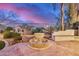 Scenic backyard view featuring a stone fountain, patio, and lush greenery, creating a tranquil outdoor setting at 12451 W Nadine Way, Peoria, AZ 85383