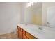 Bathroom features a double sink vanity with wood cabinets and tile flooring at 12451 W Nadine Way, Peoria, AZ 85383