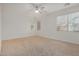 Bright, airy bedroom with neutral carpet, ceiling fan, and ample natural light at 12451 W Nadine Way, Peoria, AZ 85383
