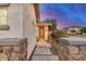 Inviting walkway with decorative stone columns leads to the beautiful wooden front door at 12451 W Nadine Way, Peoria, AZ 85383
