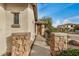 Inviting walkway with decorative stone columns leads to the beautiful wooden front door at 12451 W Nadine Way, Peoria, AZ 85383