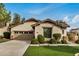 Single-story home with a well-maintained lawn, spacious driveway, and desert landscaping at 12451 W Nadine Way, Peoria, AZ 85383