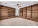 Open living room showcasing custom built-in bookshelves with bench seating and large windows at 12451 W Nadine Way, Peoria, AZ 85383
