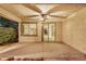 Covered patio with ceiling fan, providing a relaxing outdoor space for entertaining or enjoying quiet evenings at 12451 W Nadine Way, Peoria, AZ 85383
