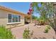 Charming backyard featuring desert landscaping, a fountain, and a covered patio at 12937 W El Sueno Ct, Sun City West, AZ 85375