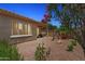 Charming backyard featuring desert landscaping, a fountain, and a covered patio at 12937 W El Sueno Ct, Sun City West, AZ 85375