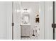 Charming powder room with black and white floor tiles at 12937 W El Sueno Ct, Sun City West, AZ 85375