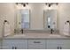 Bathroom featuring dual sinks with marble countertop and matte black hardware at 12937 W El Sueno Ct, Sun City West, AZ 85375
