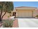 Single-story home with tile roof, desert landscaping, and large garage doors exudes Southwestern charm at 12937 W El Sueno Ct, Sun City West, AZ 85375