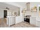 Bright, white kitchen with stainless steel appliances, an island, and hardwood floors at 12937 W El Sueno Ct, Sun City West, AZ 85375