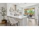 Bright kitchen with quartz counters, stainless appliances, and a breakfast bar overlooking the patio at 12937 W El Sueno Ct, Sun City West, AZ 85375