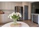 Bright eat-in kitchen with stainless steel appliances and white cabinets at 12937 W El Sueno Ct, Sun City West, AZ 85375