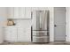 Clean white cabinets paired with stainless steel refrigerator at 12937 W El Sueno Ct, Sun City West, AZ 85375