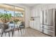 Bright kitchen with quartz counters, stainless appliances, and a breakfast nook overlooking the patio at 12937 W El Sueno Ct, Sun City West, AZ 85375