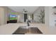 Modern kitchen with quartz countertop, stainless sink, and an open view to the living room at 12937 W El Sueno Ct, Sun City West, AZ 85375