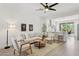 Inviting living room featuring neutral colors, comfortable seating, and seamless kitchen access at 12937 W El Sueno Ct, Sun City West, AZ 85375