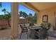 The covered patio features a fire pit, outdoor seating, and a charming landscaped backyard at 12937 W El Sueno Ct, Sun City West, AZ 85375
