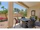 Covered patio showcases backyard landscaping with outdoor seating and a water feature at 12937 W El Sueno Ct, Sun City West, AZ 85375