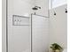 Modern walk-in shower with white tile, black trim, and storage niche at 12937 W El Sueno Ct, Sun City West, AZ 85375