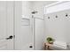 Modern walk-in shower with white tile and black hardware at 12937 W El Sueno Ct, Sun City West, AZ 85375