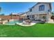 Inviting backyard with a refreshing pool, lush green lawn, and comfortable patio furniture at 13620 N 82Nd Ln, Peoria, AZ 85381
