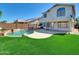 Lush backyard oasis featuring a sparkling in-ground pool and a well-maintained artificial lawn at 13620 N 82Nd Ln, Peoria, AZ 85381