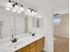 Bright bathroom featuring a double sink vanity and contemporary lighting fixtures at 13620 N 82Nd Ln, Peoria, AZ 85381